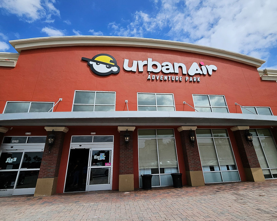 front of urban air building with sign